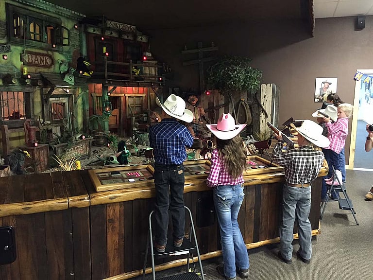 Kid's shooting at the Cody Firearms Experience arcade